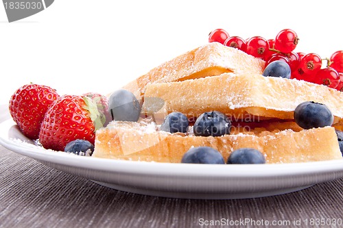 Image of sweet fresh tasty waffles with mixed fruits isolated