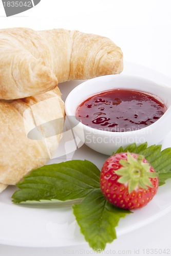 Image of deliscios fresh croissant with strawberry jam isolated