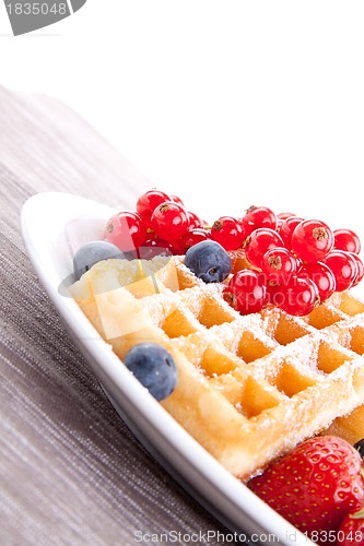 Image of sweet fresh tasty waffles with mixed fruits isolated