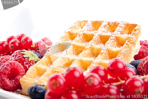 Image of sweet fresh tasty waffles with mixed fruits isolated