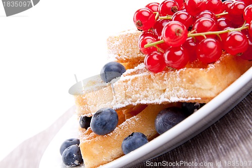 Image of sweet fresh tasty waffles with mixed fruits isolated