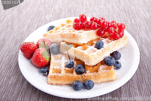 Image of sweet fresh tasty waffles with mixed fruits isolated