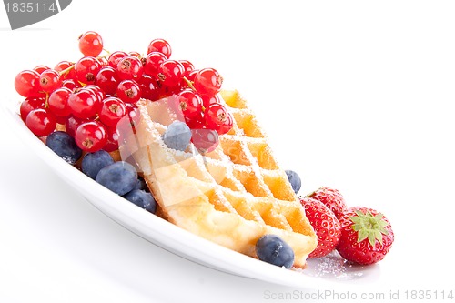 Image of sweet fresh tasty waffles with mixed fruits isolated