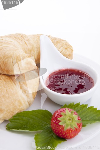 Image of deliscios fresh croissant with strawberry jam isolated