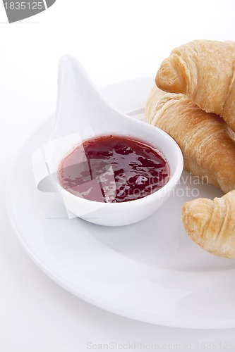 Image of deliscios fresh croissant with strawberry jam isolated