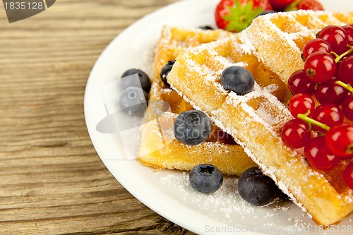 Image of fresh tasty waffer with powder sugar and mixed fruits