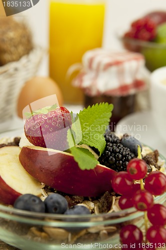 Image of tasty breakfast with flakes and fruits in morning