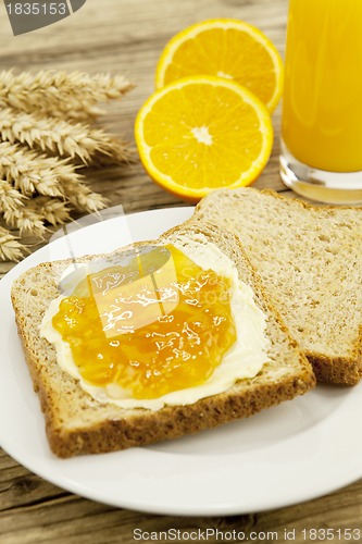 Image of tasty breackfast with toast and marmelade on table