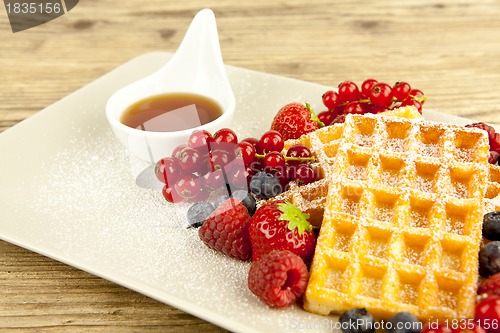 Image of fresh tasty waffer with powder sugar and mixed fruits