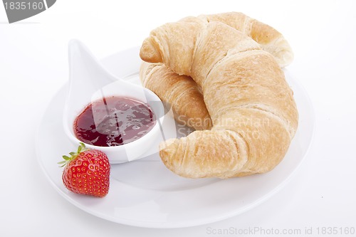 Image of deliscios fresh croissant with strawberry jam isolated