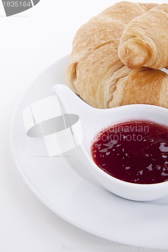 Image of deliscios fresh croissant with strawberry jam isolated