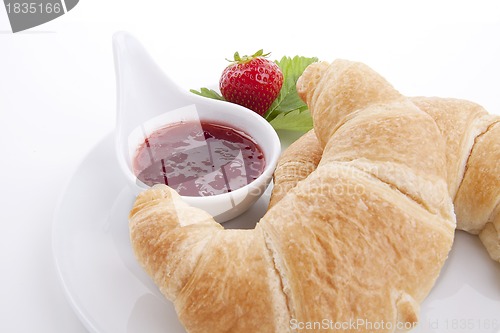 Image of deliscios fresh croissant with strawberry jam isolated