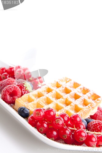 Image of sweet fresh tasty waffles with mixed fruits isolated