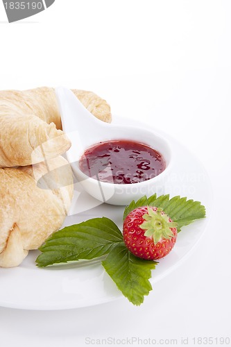 Image of deliscios fresh croissant with strawberry jam isolated
