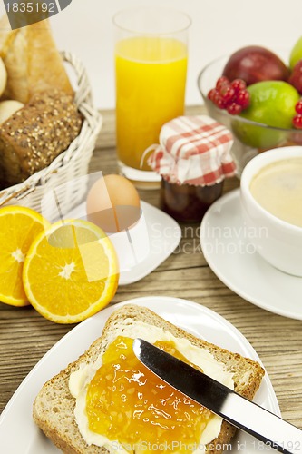 Image of tasty breackfast with toast and marmelade on table