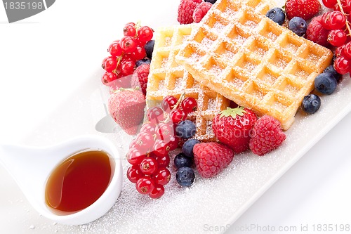 Image of sweet fresh tasty waffles with mixed fruits isolated