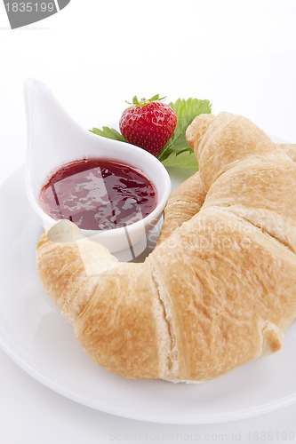Image of deliscios fresh croissant with strawberry jam isolated