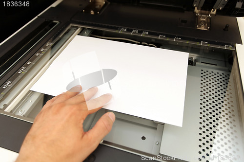 Image of A person handling with working laser copier  