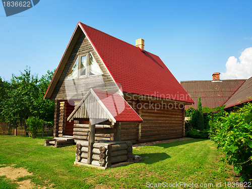 Image of wooden house and well in the yard