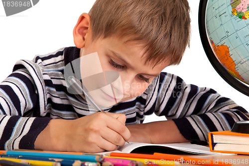 Image of Cute schoolboy is writting