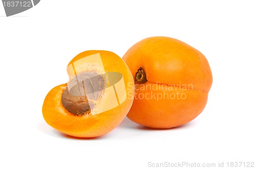 Image of Two ripe apricot sectioned by knife