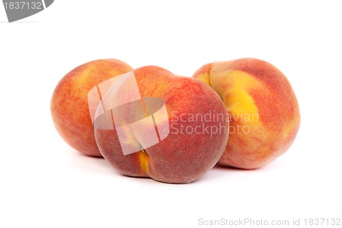 Image of Three tasty juicy peaches on a white background