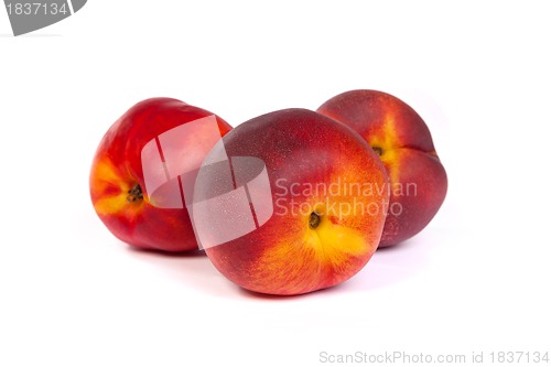 Image of Three fresh nectarines on white