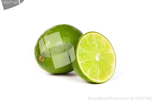 Image of One whole lime and one half lime on white
