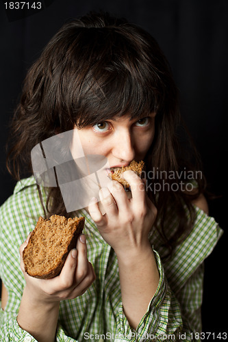 Image of beggar woman eating bread 