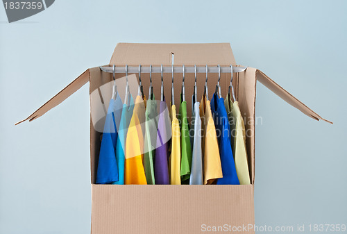 Image of Bright clothing in a wardrobe box for easy moving