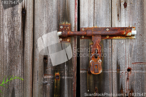 Image of old lock on closed door