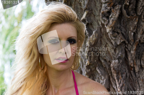 Image of Portrait of a beautiful blond woman in the park.