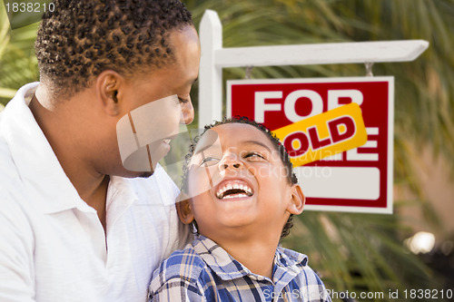 Image of Mixed Race Father and Son In Front of Sold Real Estate Sign