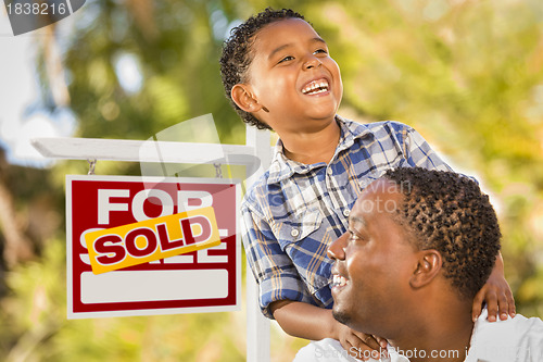 Image of Mixed Race Father and Son In Front of Sold Real Estate Sign