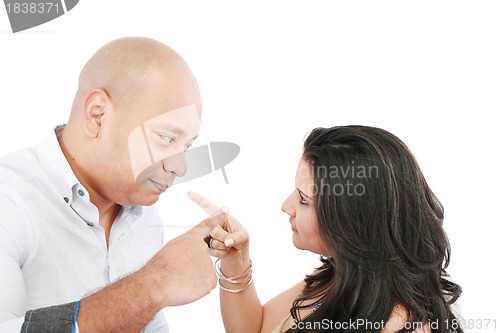 Image of Young couple pointing at each other against a white background 