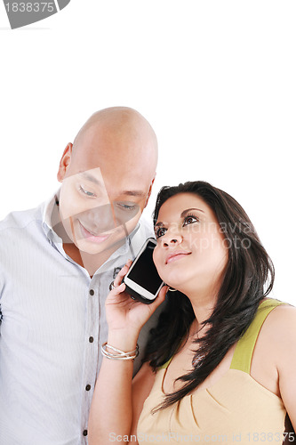 Image of Happy young couple using cell phone isolated on a white backgrou