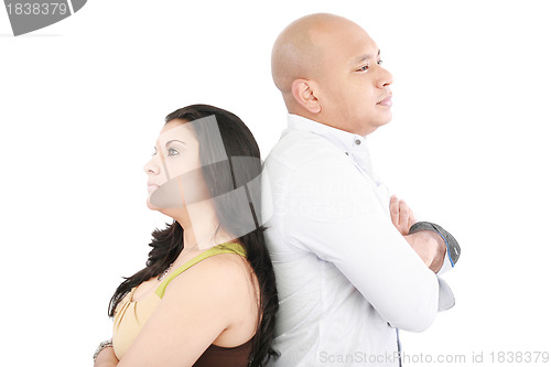 Image of Young couple standing back to back having relationship difficult