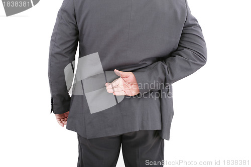 Image of Liar businessman with crossed fingers at back. Isolated on white
