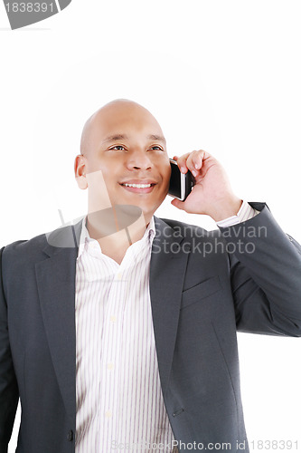 Image of A smiling African American business man talking on cellphone ove