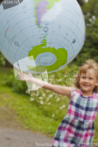 Image of Girl throwing an earth globe