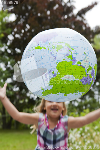 Image of Girl throwing an earth globe