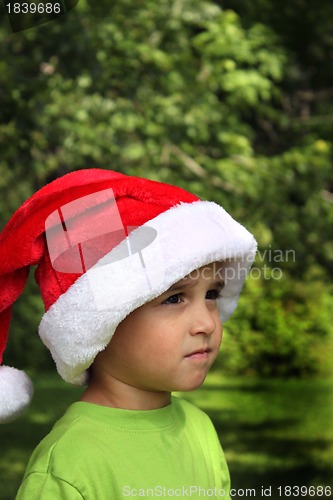 Image of Little boy wearing Santa hat