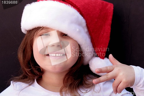 Image of Pretty little girl in santa hat