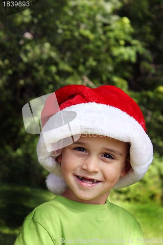 Image of Happy little boy in Santa hat