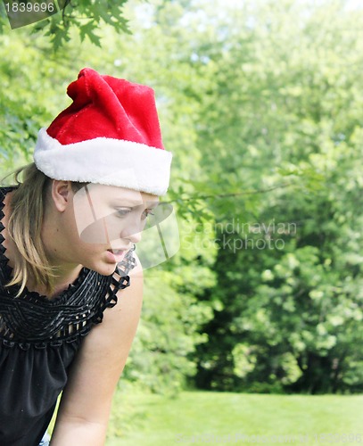 Image of Cute woman wearing santa hat