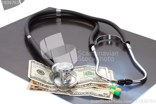 Image of Stthoscope, dollars and x-ray