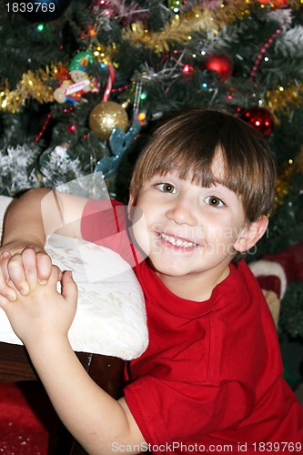 Image of Little boy under Christmas tree