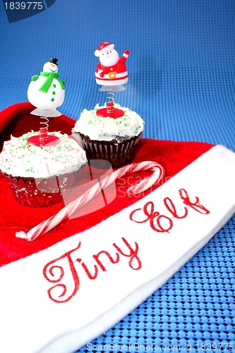 Image of Santa hat with two cupcakes decorated