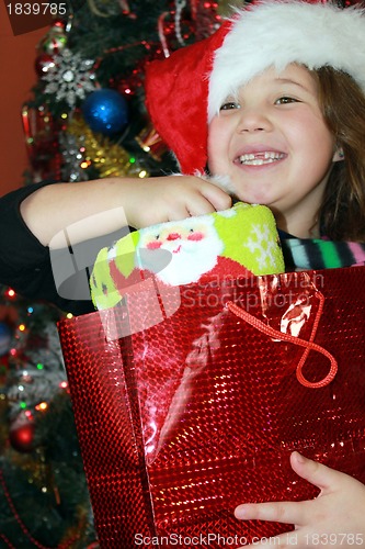 Image of Pretty girl opening Christmas package