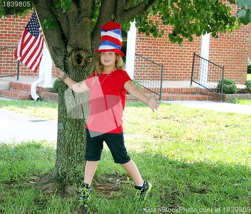 Image of Pretty girl waving flag for the 4th of July